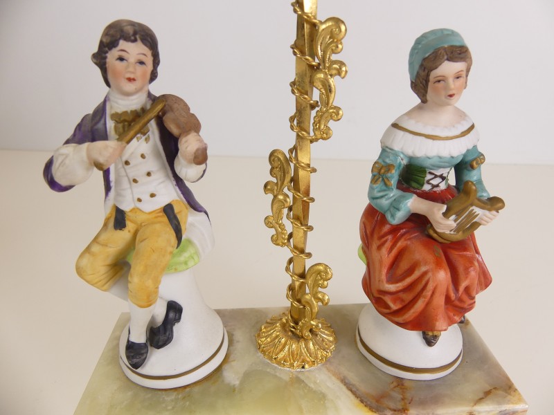 Vintage opwindbare klok met porseleinen figuren